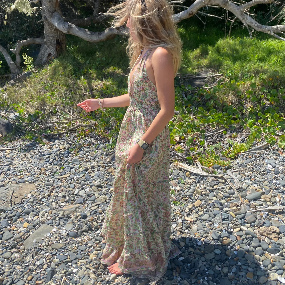 Model wearing the Wanderlust Dress on a beach